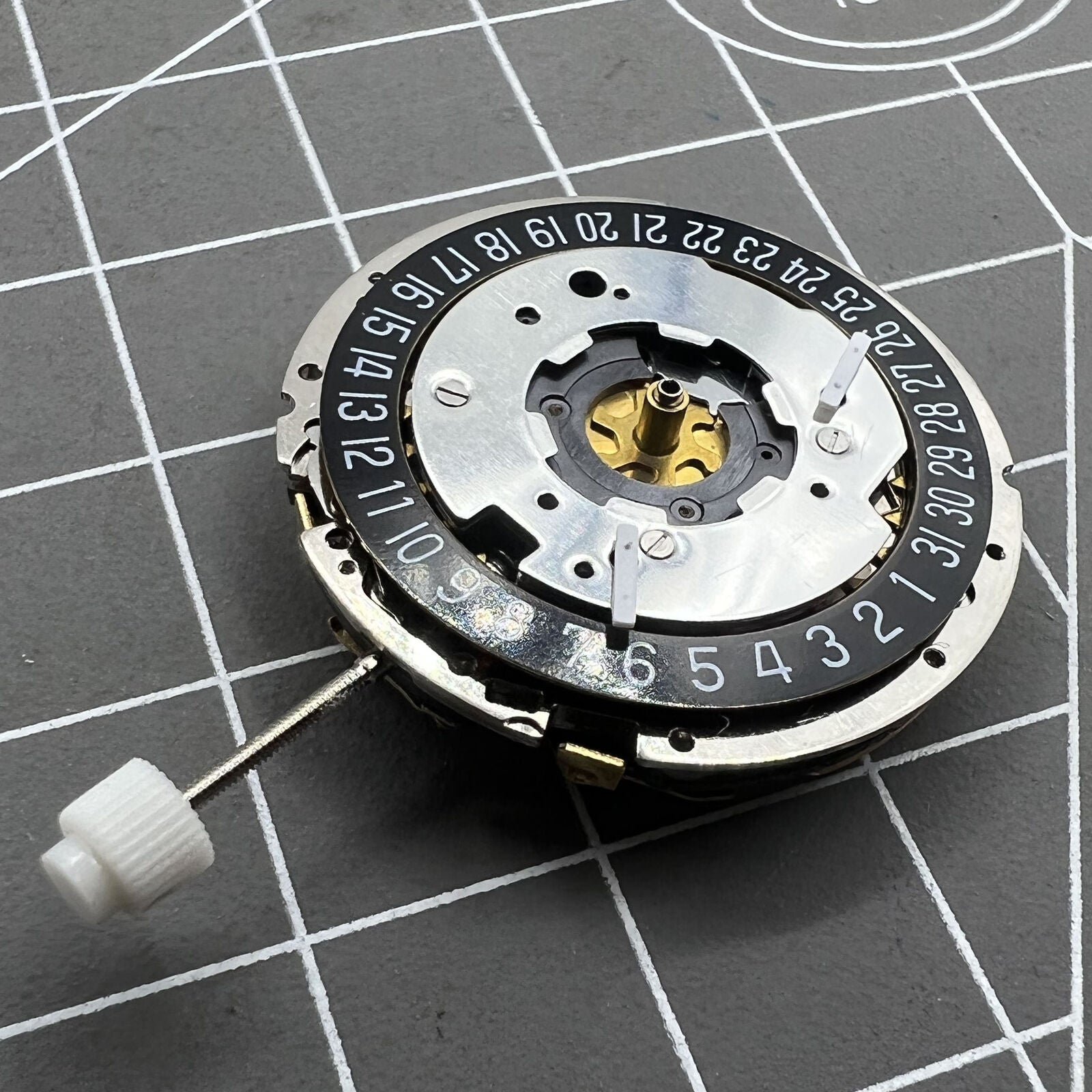 Golden ISA 8271 quartz watch movement with multifunctional date display positioned at 6 o'clock.