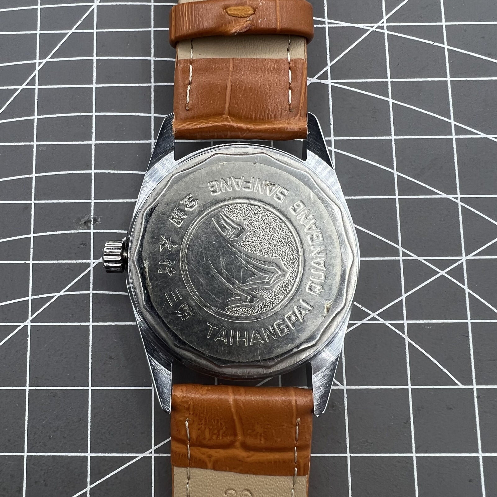 TAIHANG 38mm manual mechanical watch with silver dial, golden nails, round case, and 17 jewels for classic style.