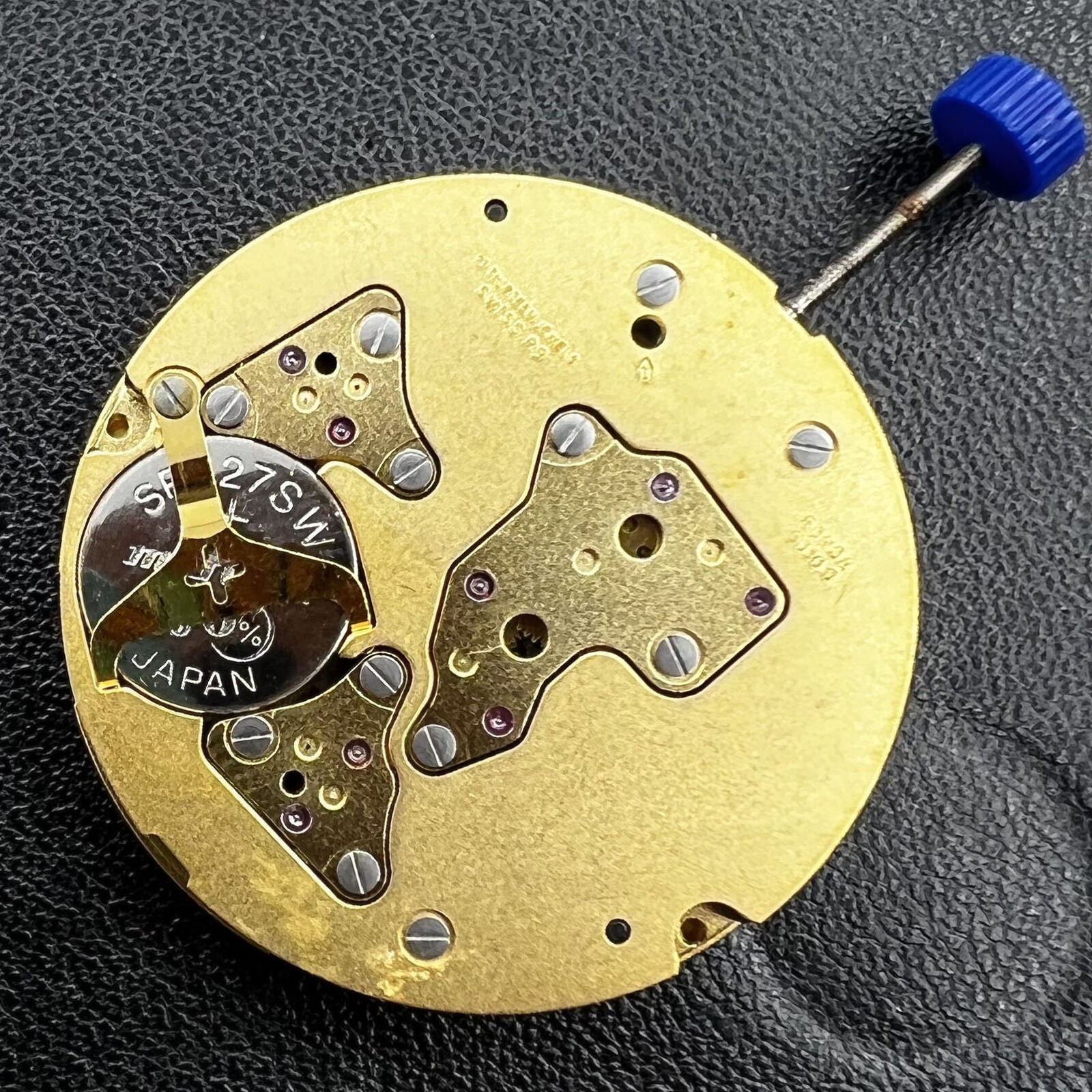 Swiss Made Ronda 5030D quartz movement with black date disk at 4 o'clock for precision watch repair.