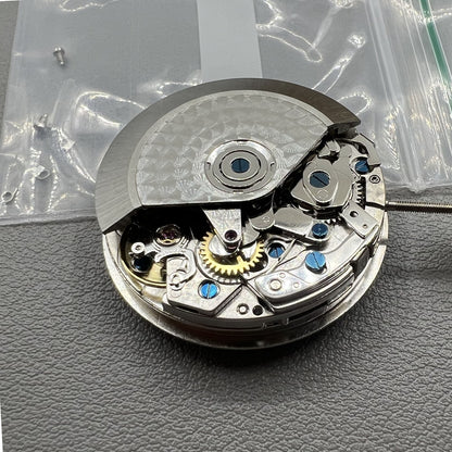 Chronograph watch accessory with ETA 7750 movement, white dial, calendar at 6, second hand at 9.