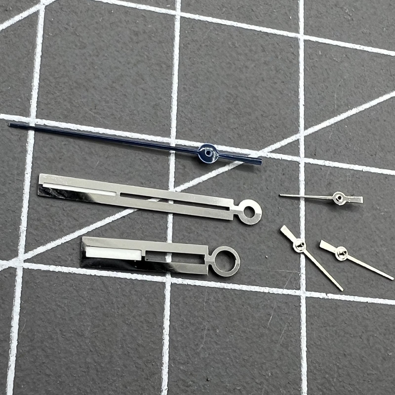 Luminous silver watch hands by Ronda for 5021D quartz movement, perfect for accurate watch repairs.