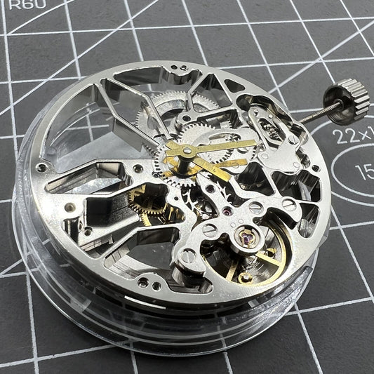 Dandong 8306 silver watch with hollow dial, 2 hands, automatic mechanical movement, elegant design.