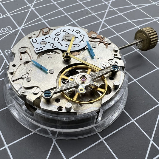 Multifunctional Date@12 watch with bare balance wheel, automatic mechanical movement, showcasing precision.