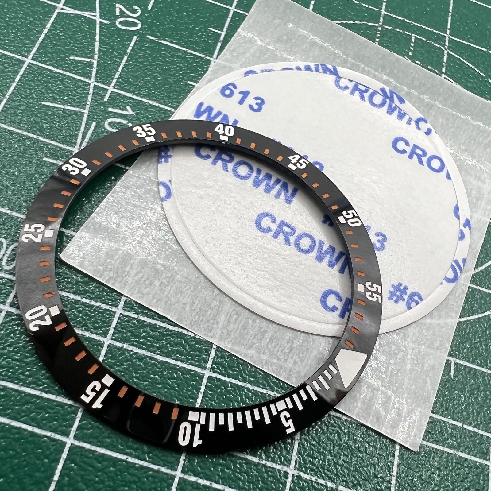 Black ceramic watch bezel insert 38mm with orange graduations, perfect for repairs and customization.