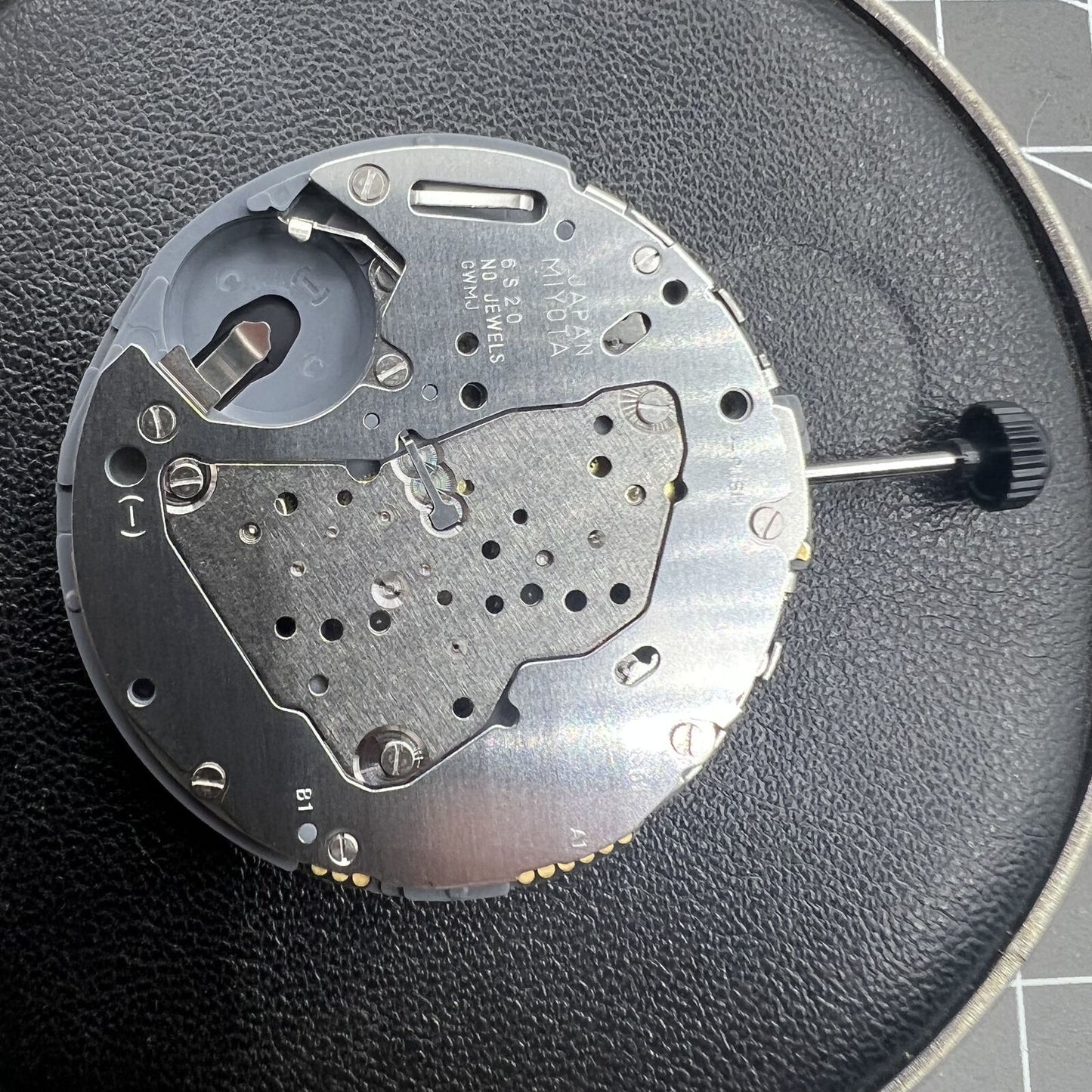 Miyota 6S20 quartz watch movement with date at 3, small seconds at 6 and 9, precise timekeeping.