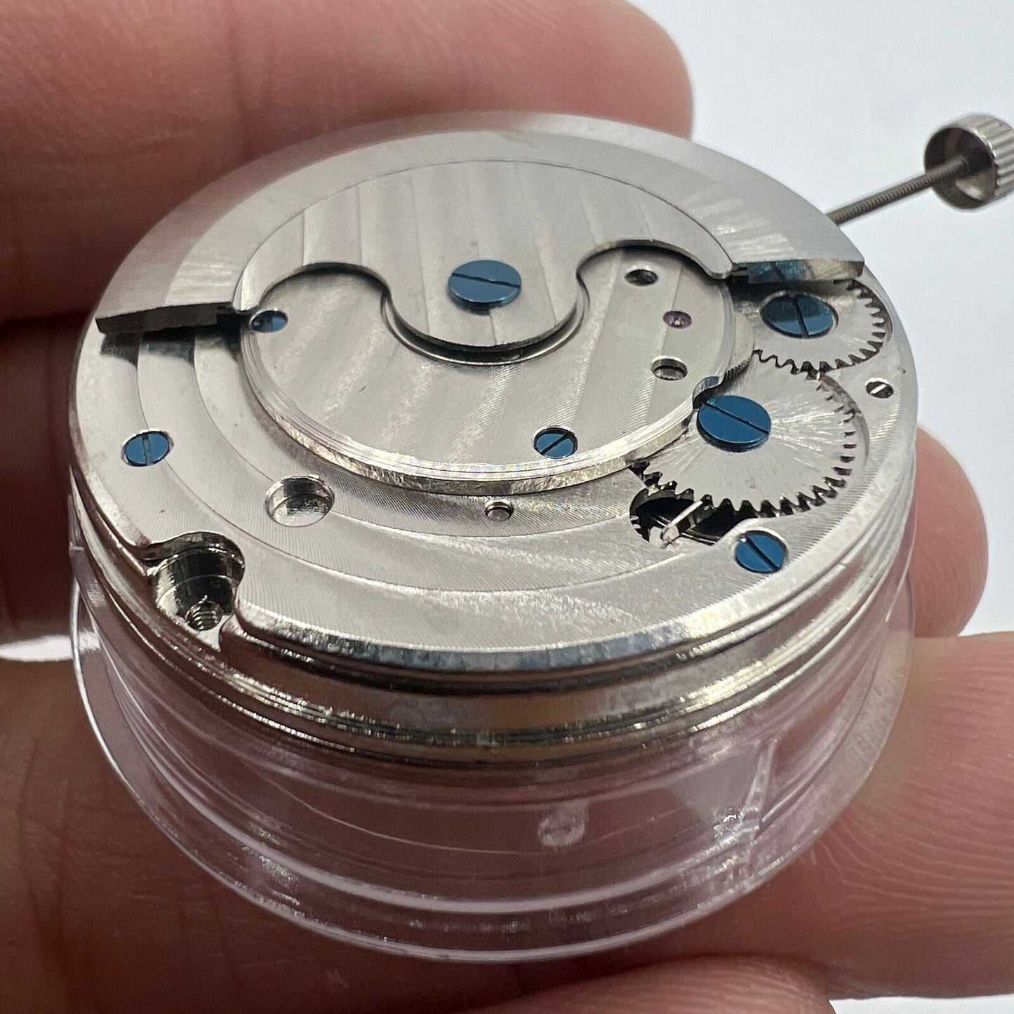 Multifunctional automatic watch with kinetic tourbillon, showcasing sleek mechanical craftsmanship.