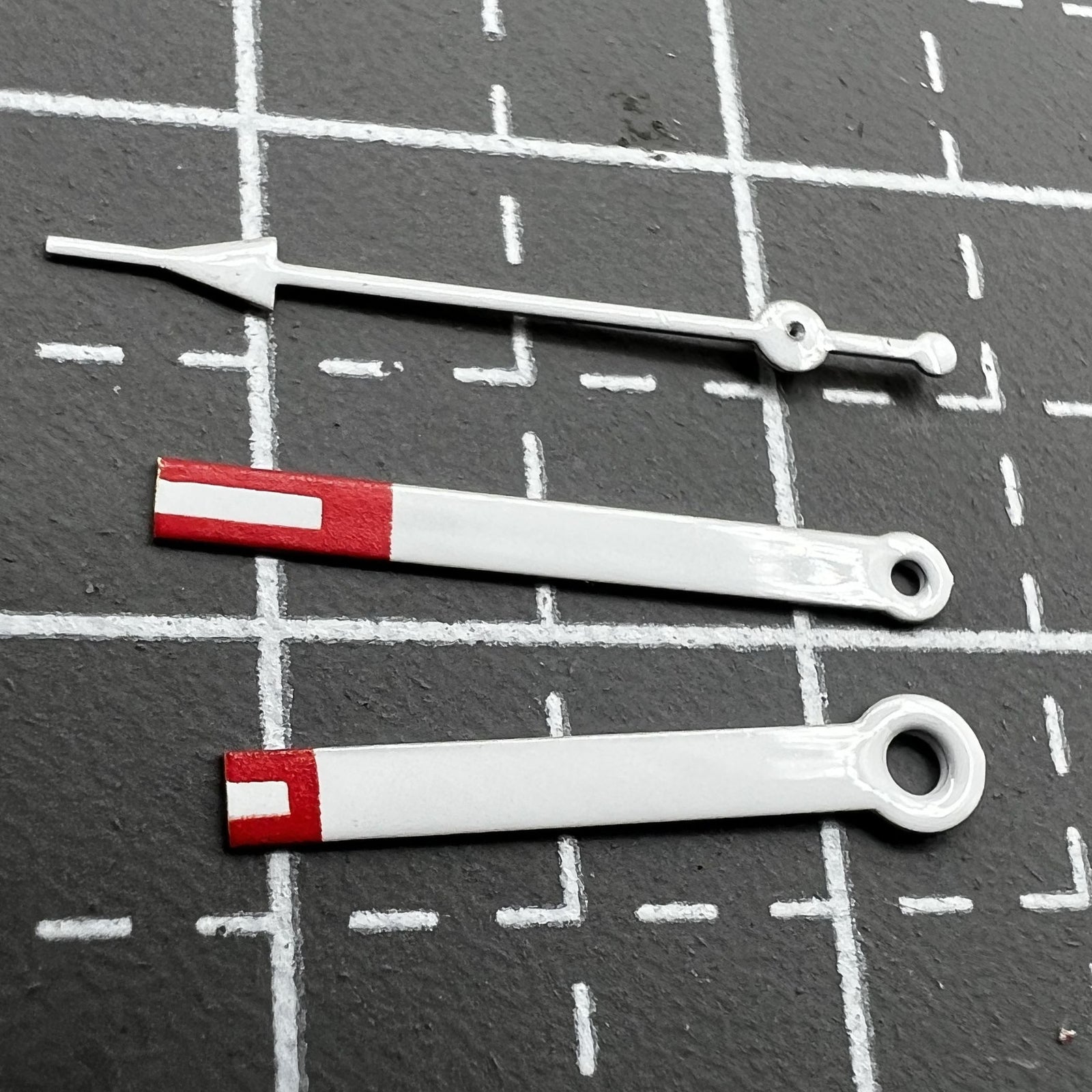Red arrow-style watch hands set by Miyota, designed for 2035 quartz movement, precise and stylish timekeeping.