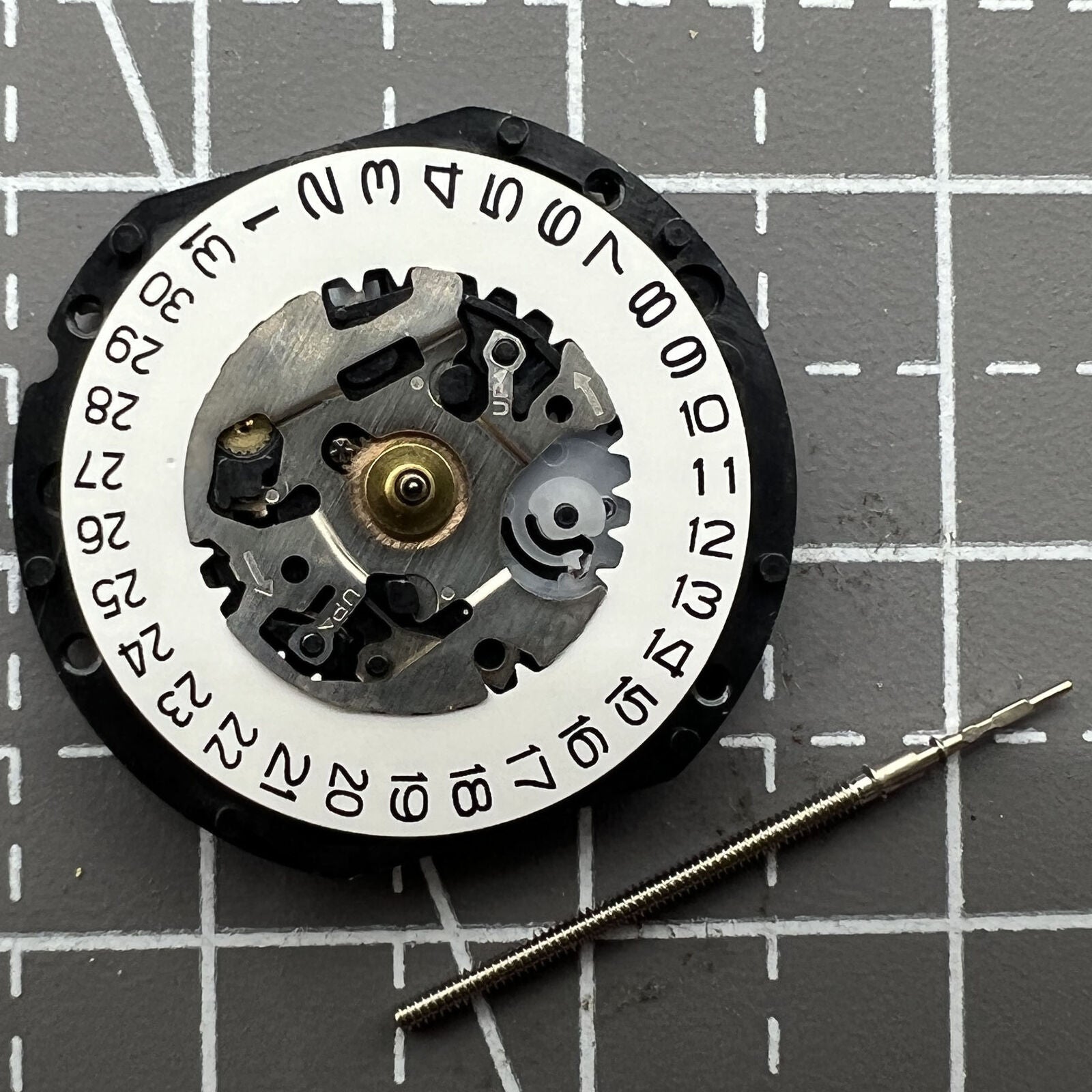Hattori Epson VX12 quartz watch movement with date at 3, precision Japanese craftsmanship.