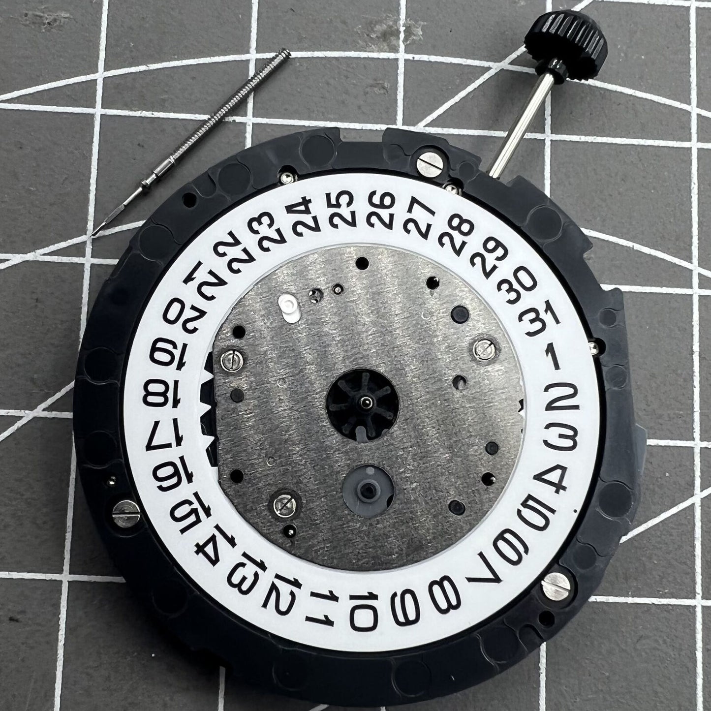 Miyota 6S20 quartz watch movement with date at 3, three hands, small seconds at 6 and 9, precision timekeeping.