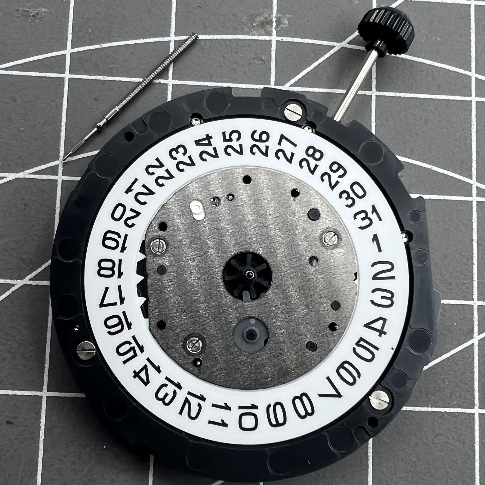 Miyota 6S20 quartz watch movement with date at 3, three hands, small seconds at 6 and 9, precision timekeeping.