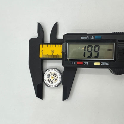 Hattori Epson VX12 quartz watch movement showing date at 3, precise Japanese craftsmanship detail.