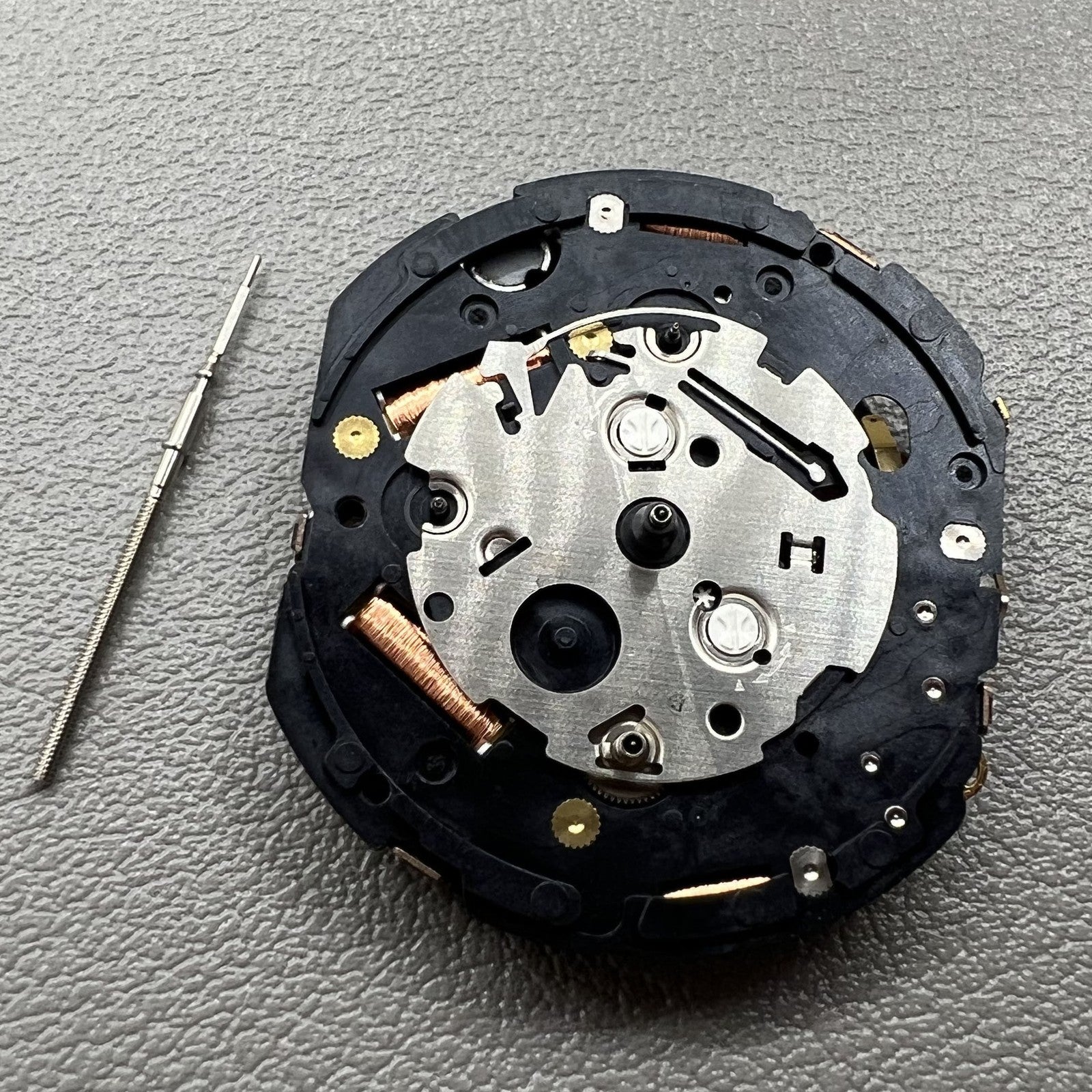 Seiko 7T86A quartz watch movement replacement part, precision Japanese craftsmanship for repairs.