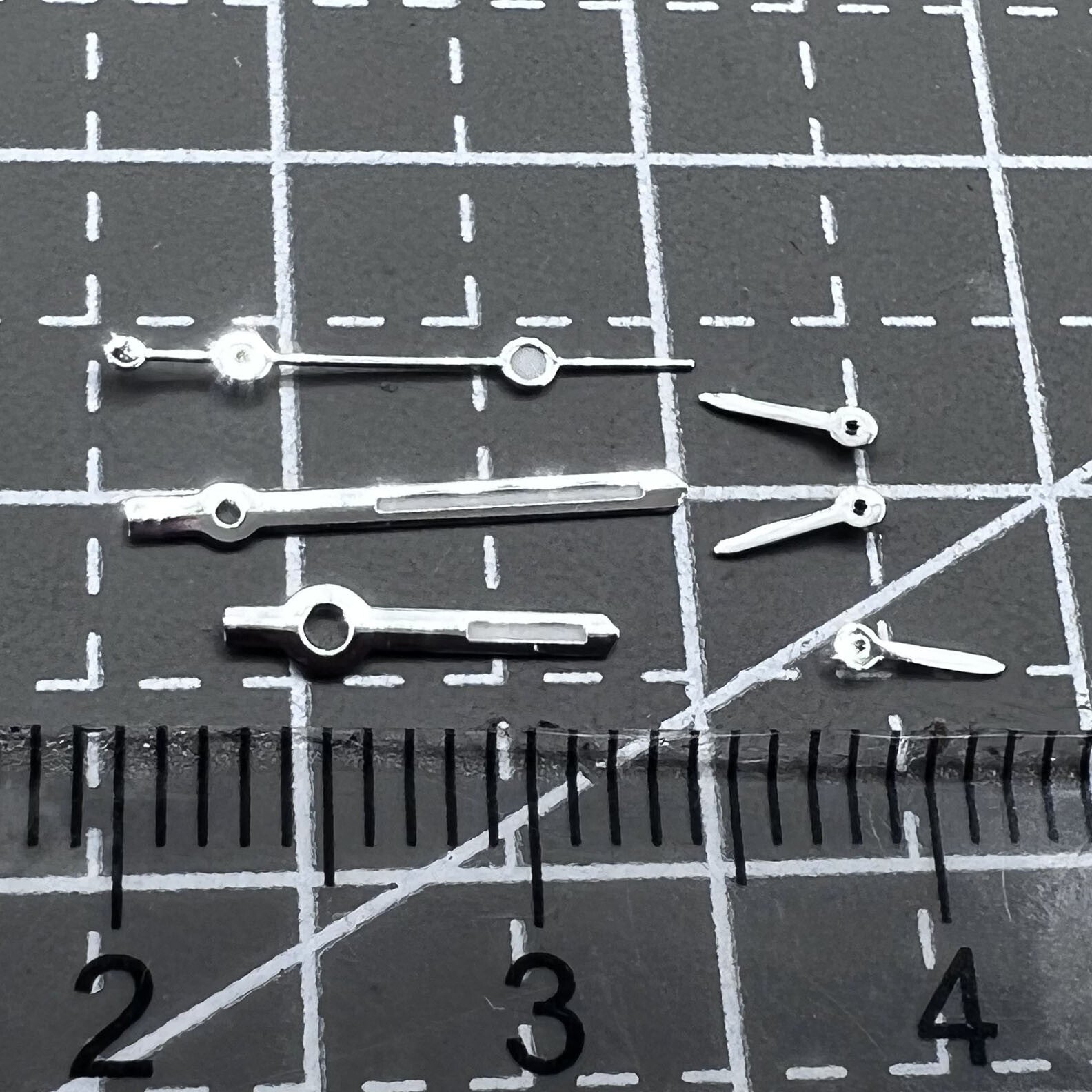 Silver arrow-shaped watch hands with green luminous trim, compatible with VD53 VD54 VD57 movements, 2 sets per pack.