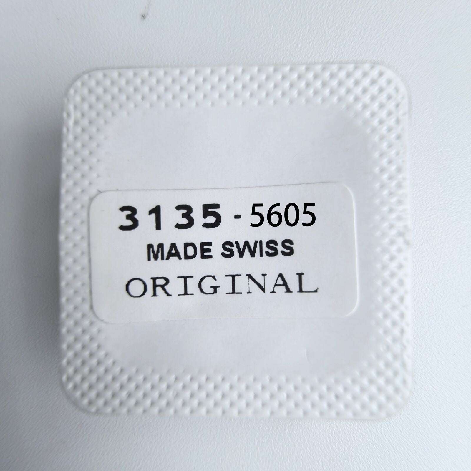 1. Close-up of Replacements 3135-5605 date indicator driving wheel screws for 3135 watch movement by Rolex.  