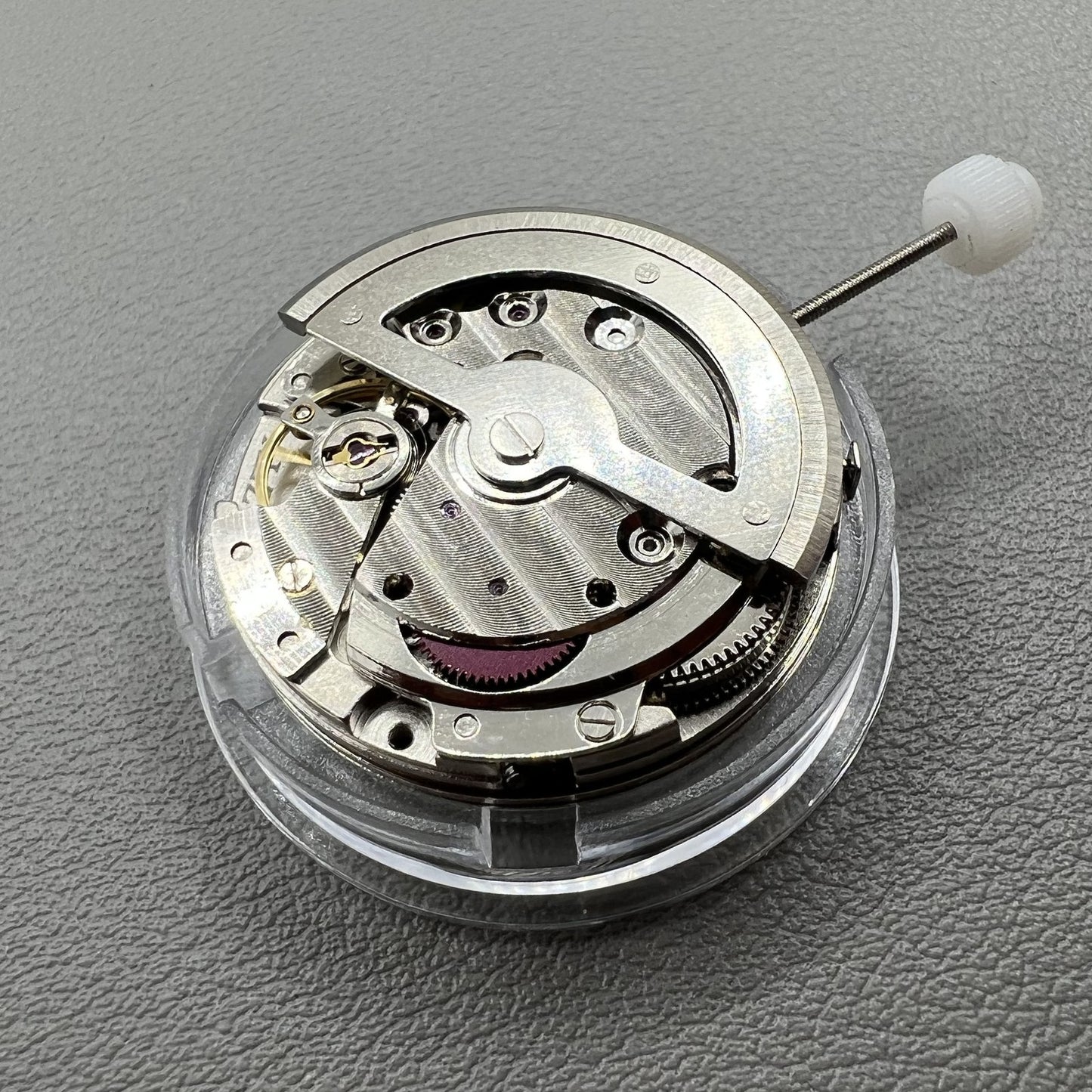 China Made 8205 automatic watch movement showing small seconds at 3, 6, and 9 o'clock positions for precise timekeeping.