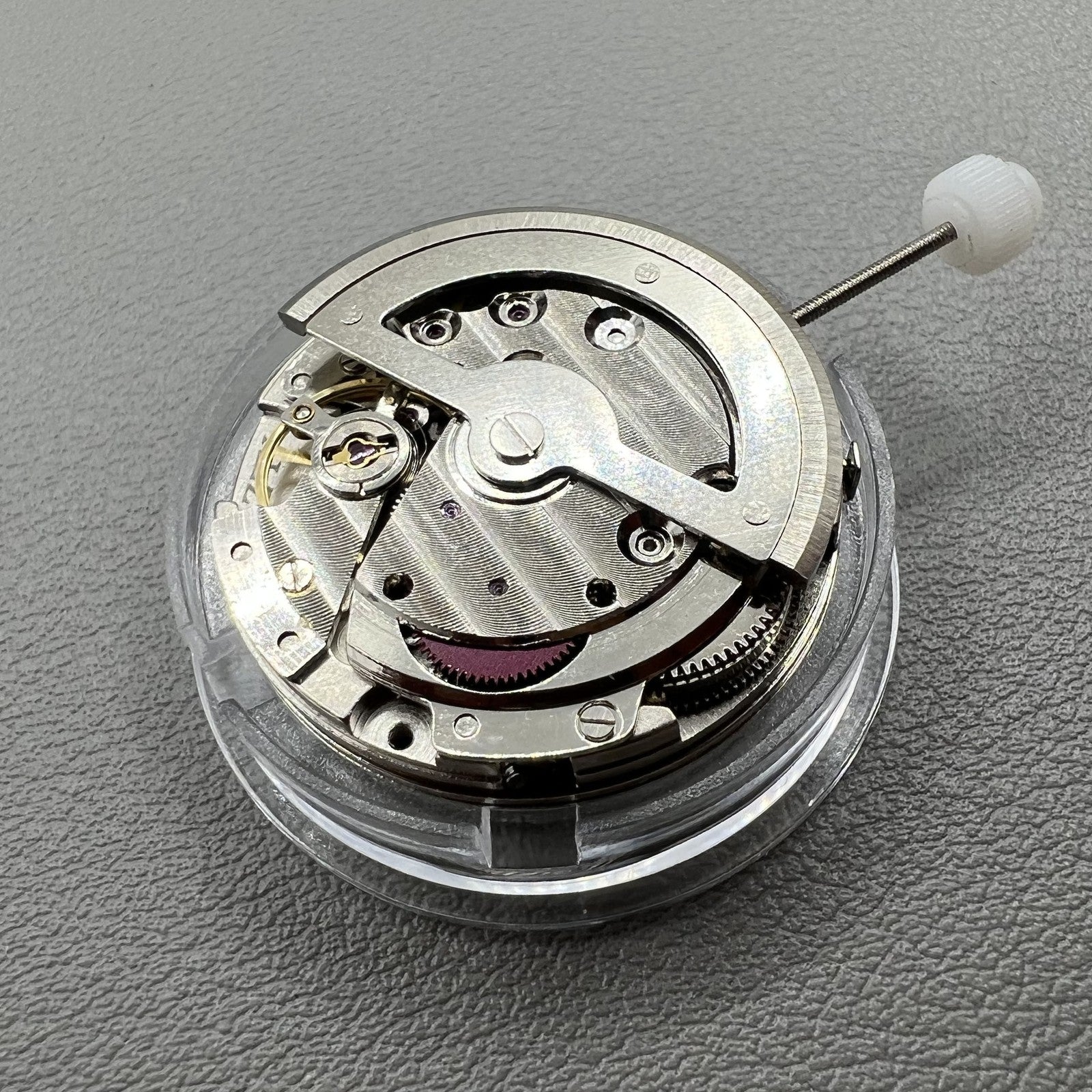China Made 8205 automatic watch movement showing small seconds at 3, 6, and 9 o'clock positions for precise timekeeping.