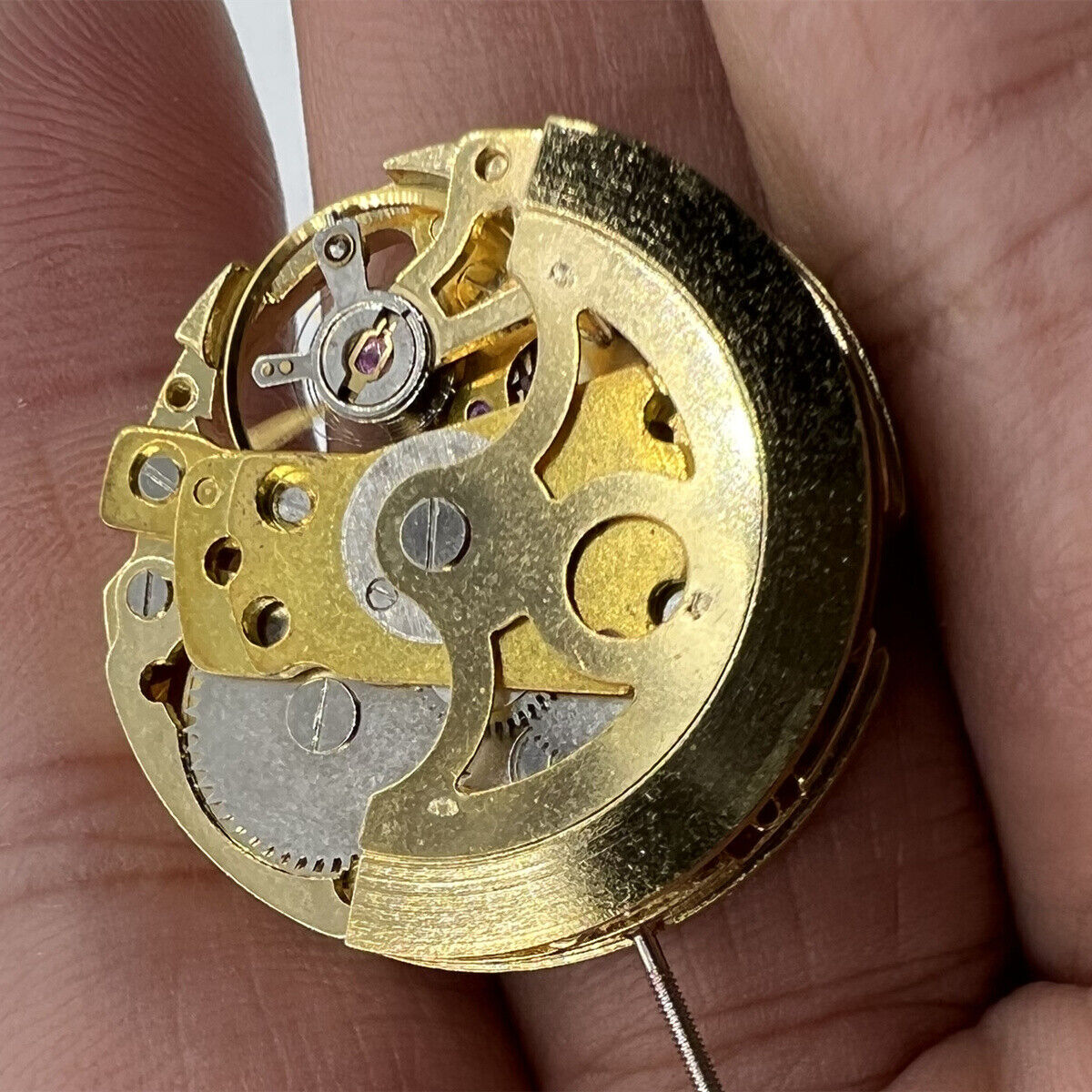 Hollow golden 26.5mm DANDONG 7120 automatic watch movement showcasing intricate mechanical design details