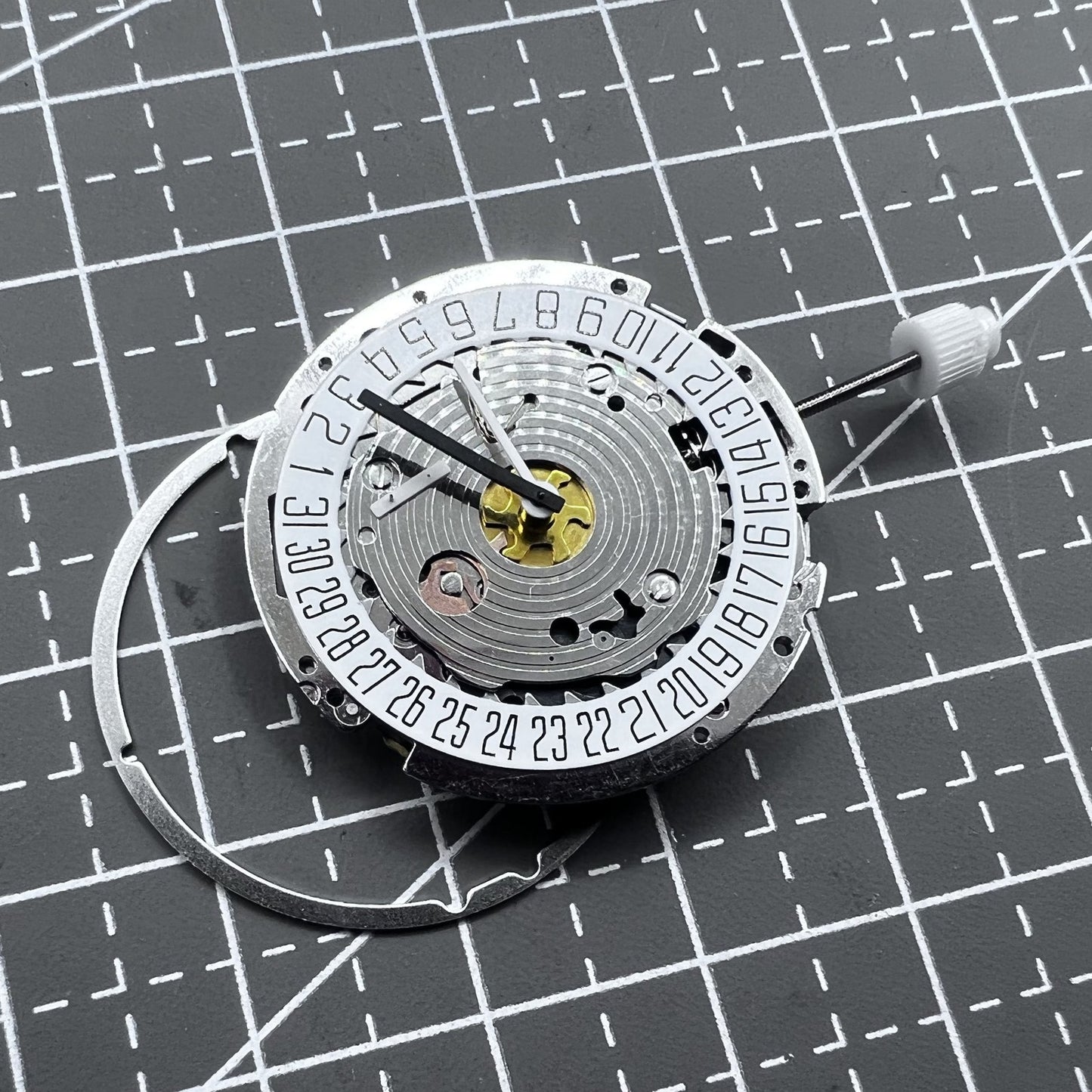 Swiss ISA 8171A quartz watch movement with white dial, four hands, and date at 6 o?clock for precise timekeeping.