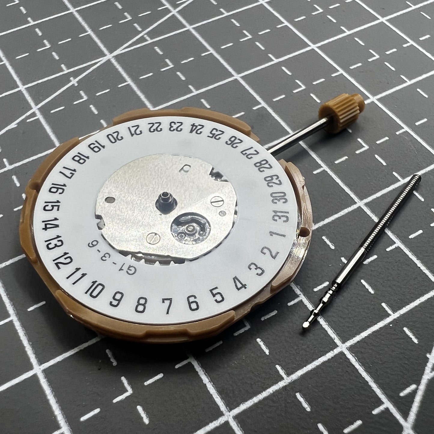 Japan Miyota GM10 watch movement with date display at 6 o'clock, precise quartz mechanism.
