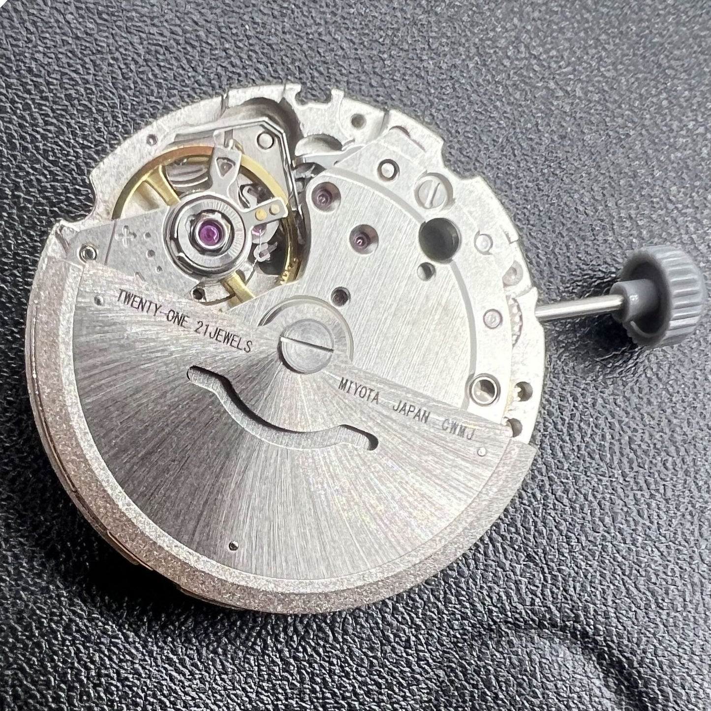 Miyota/Citizen 8200 automatic watch movement showing double calendar and precise mechanical parts.