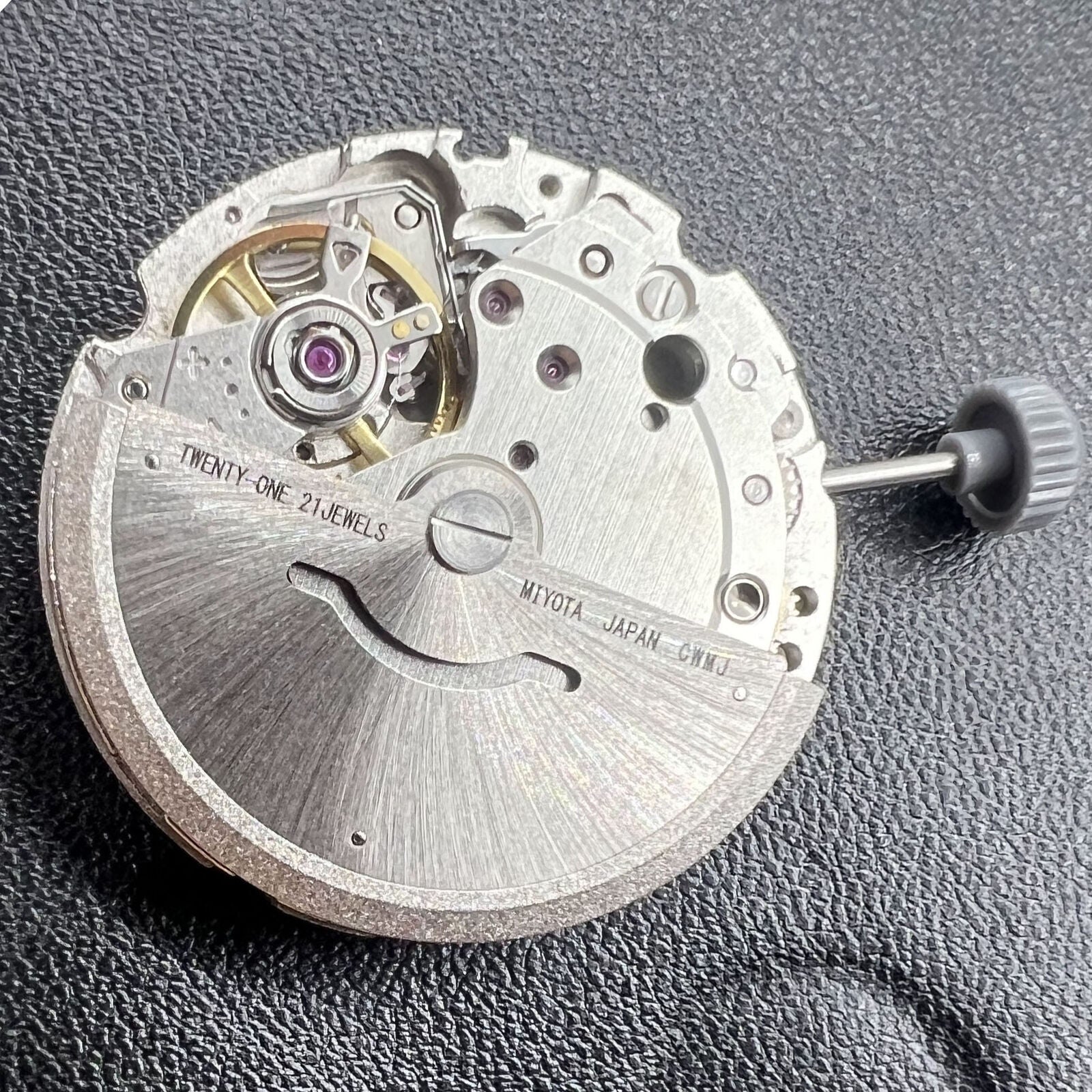 Miyota/Citizen 8200 automatic watch movement showing double calendar and precise mechanical parts.