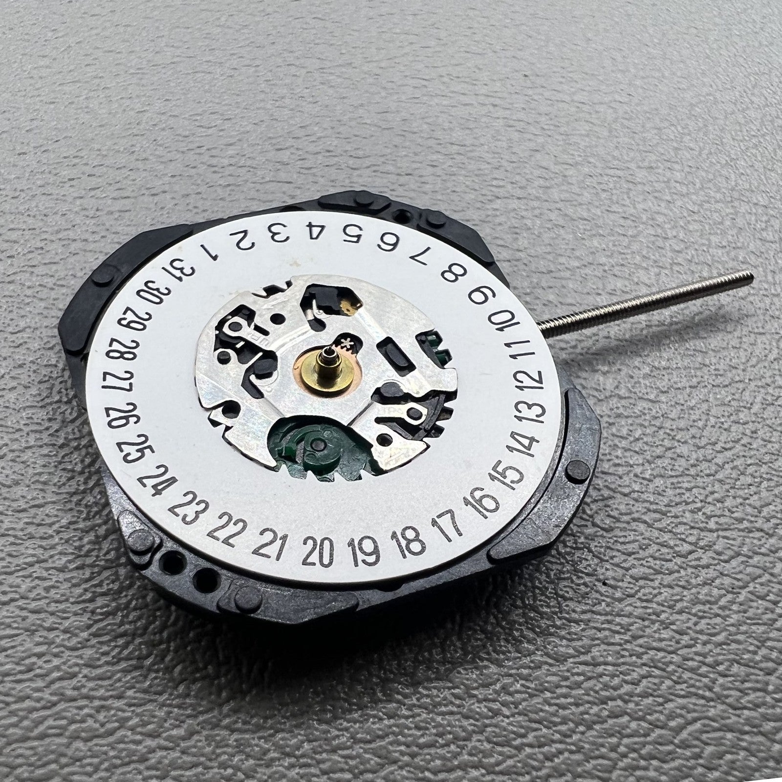 Japan V722C quartz watch movement displaying hour, minute, second hands, and date window at 6 o'clock ? reliable precision by Seiko.