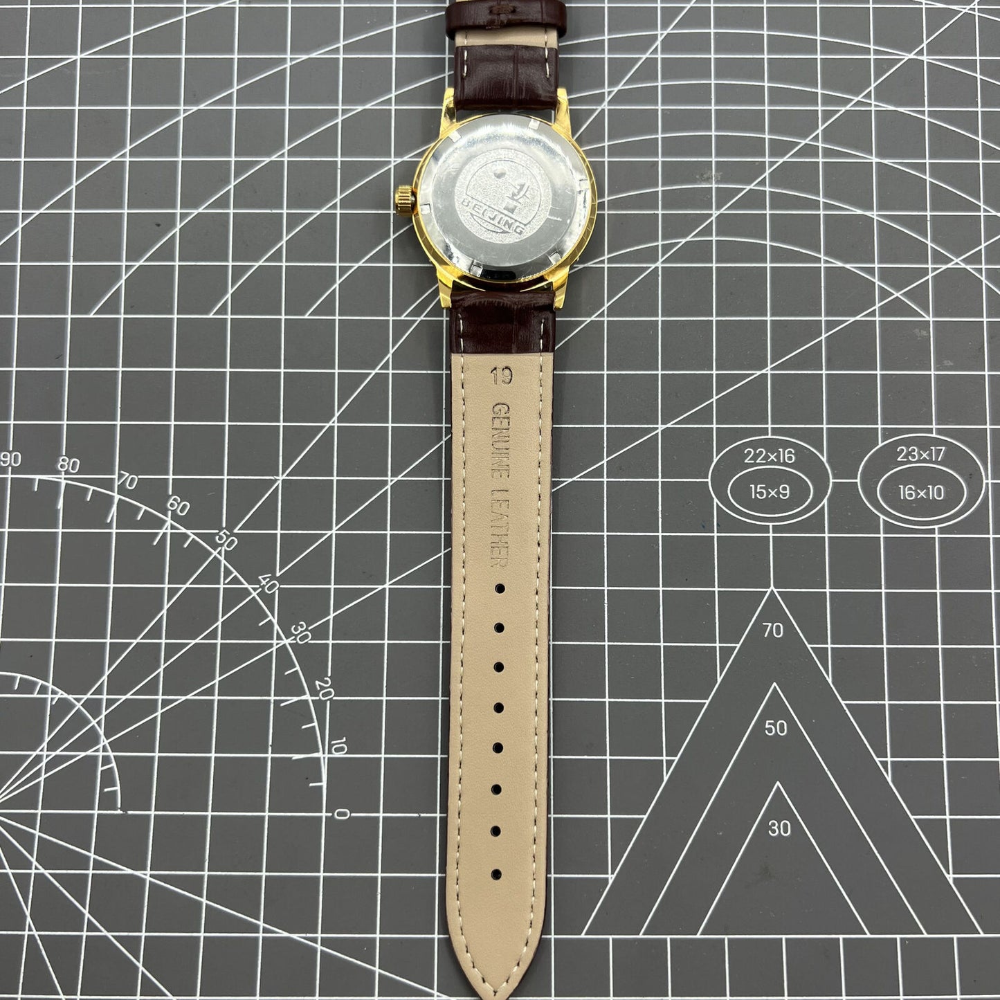 Beijing Double Rhomb mechanical watch with golden case and silver nail markers, elegant and classic style.