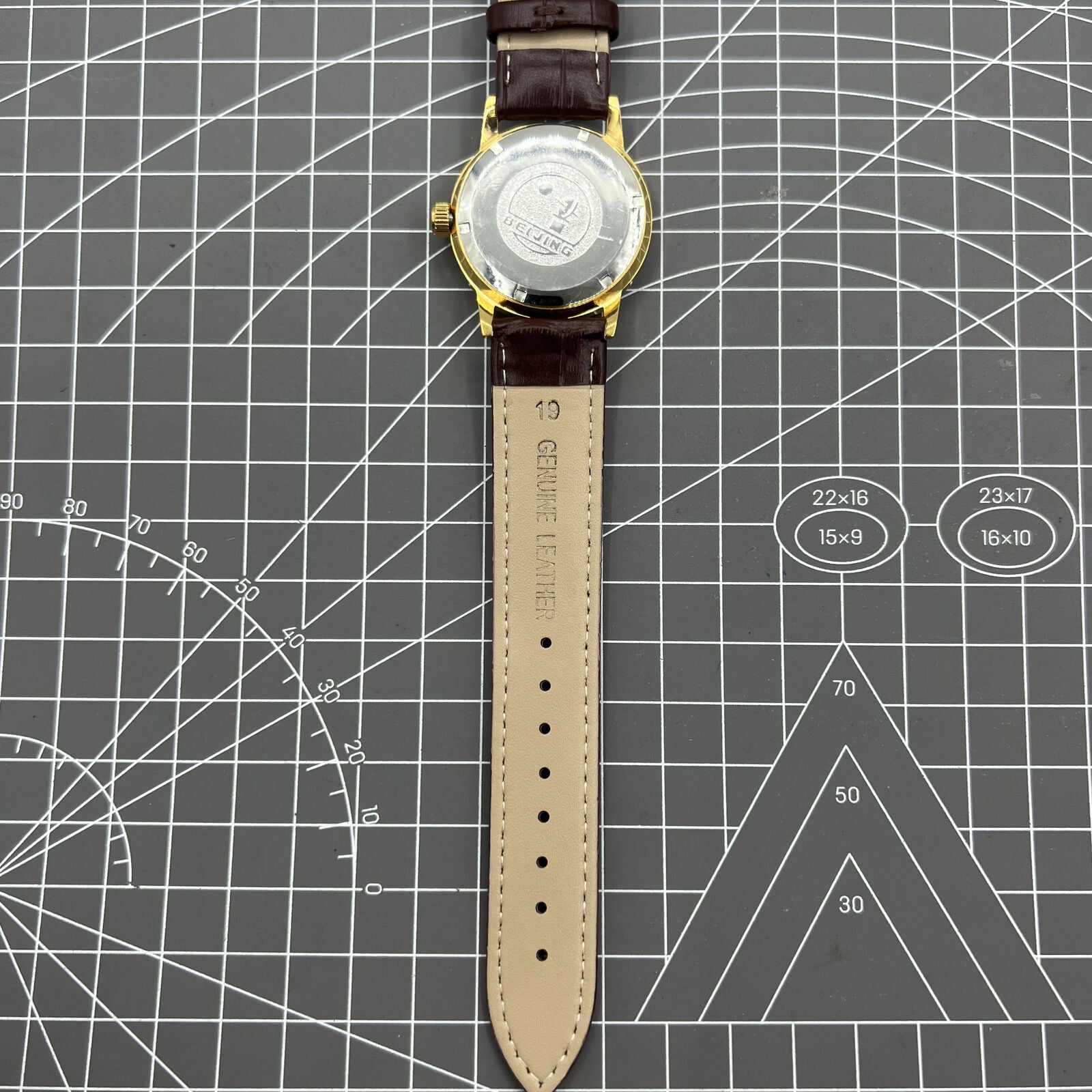 Beijing Double Rhomb mechanical watch with golden case and silver nail markers, elegant and classic style.