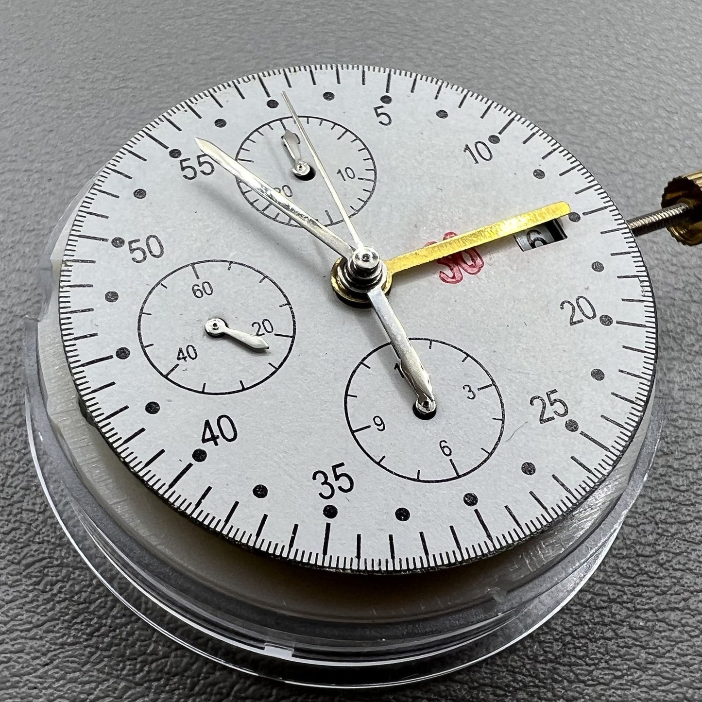 Dandong 7750 mechanical watch movement showing single calendar and small seconds subdials at 6, 9, and 12 o'clock positions for precision timekeeping.