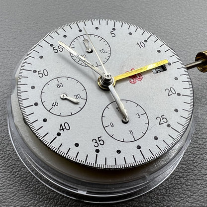 Dandong 7750 mechanical watch movement showing single calendar and small seconds subdials at 6, 9, and 12 o'clock positions for precision timekeeping.