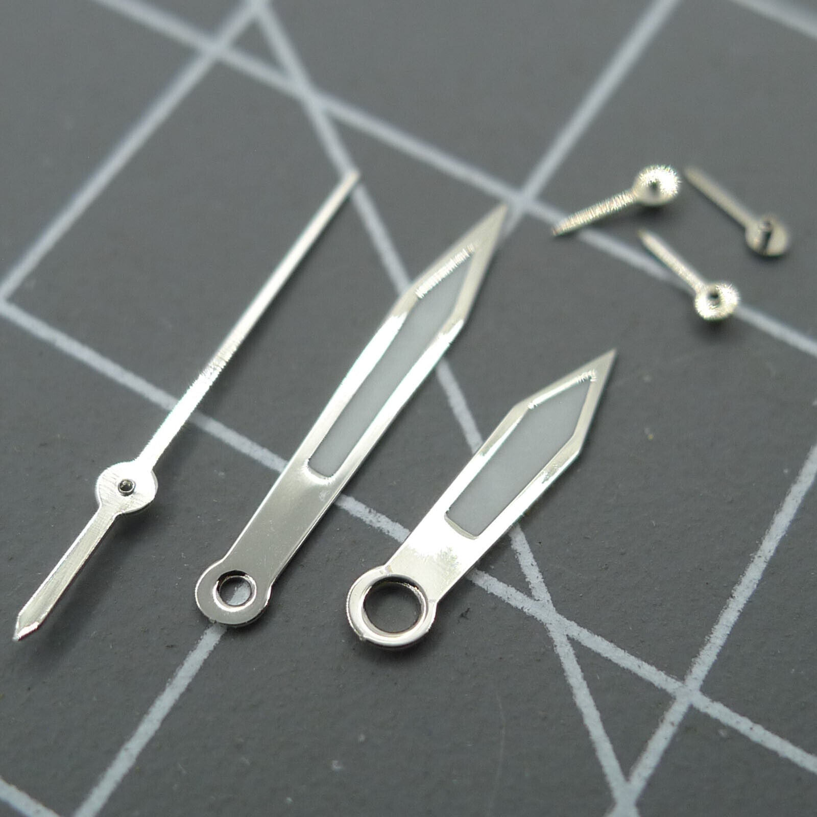 Pointed 13mm green luminous watch hands with silver trim for Miyota 0S10 movement.