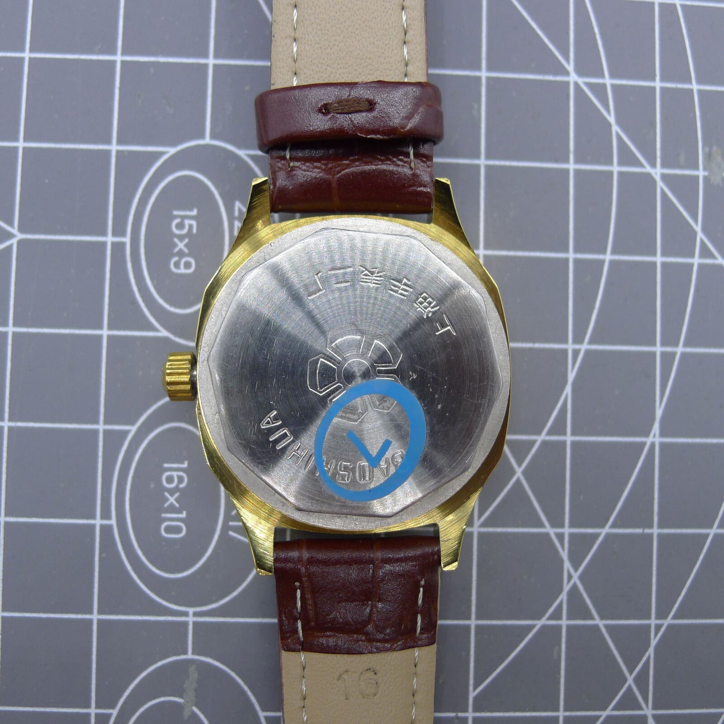 33mm Shanghai watch with blue dial, golden nail markers, square case, manual movement by Shanghai.