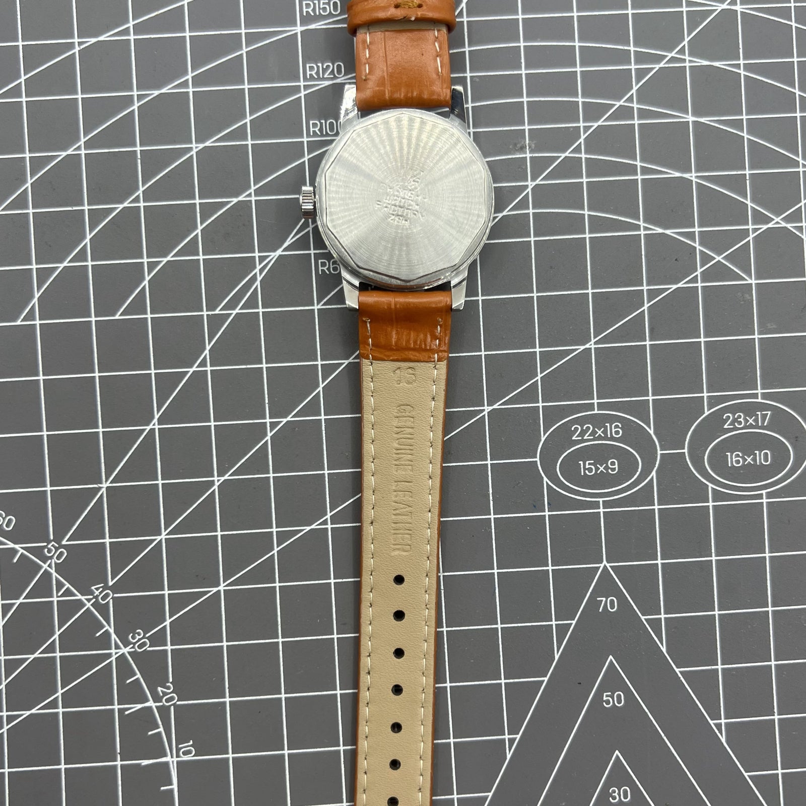 Silver 32mm Shanghai Factory manual watch with silver case and nail markers, classic mechanical design.