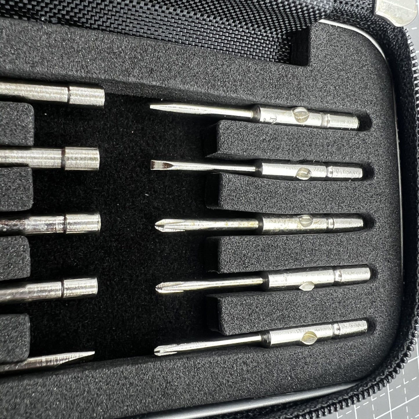 Precision screwdriver set with hex tools for watches and glasses repair, ergonomic grip.