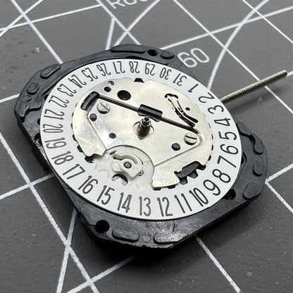 Seiko VX22 quartz watch movement with white date disks at 3 and 6 o'clock, Japan-made precision.