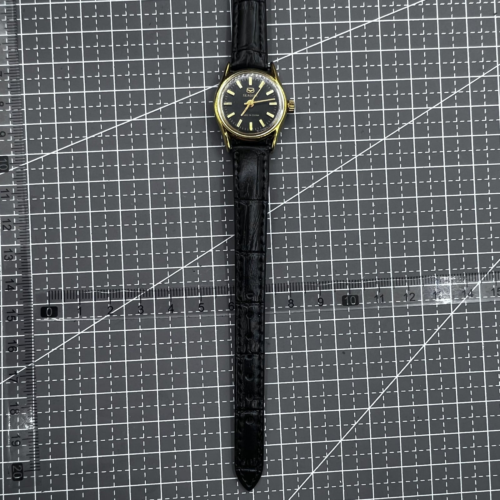 Elegant black round case ladies watch with gold accents, Tianjin Seagull manual mechanical movement.