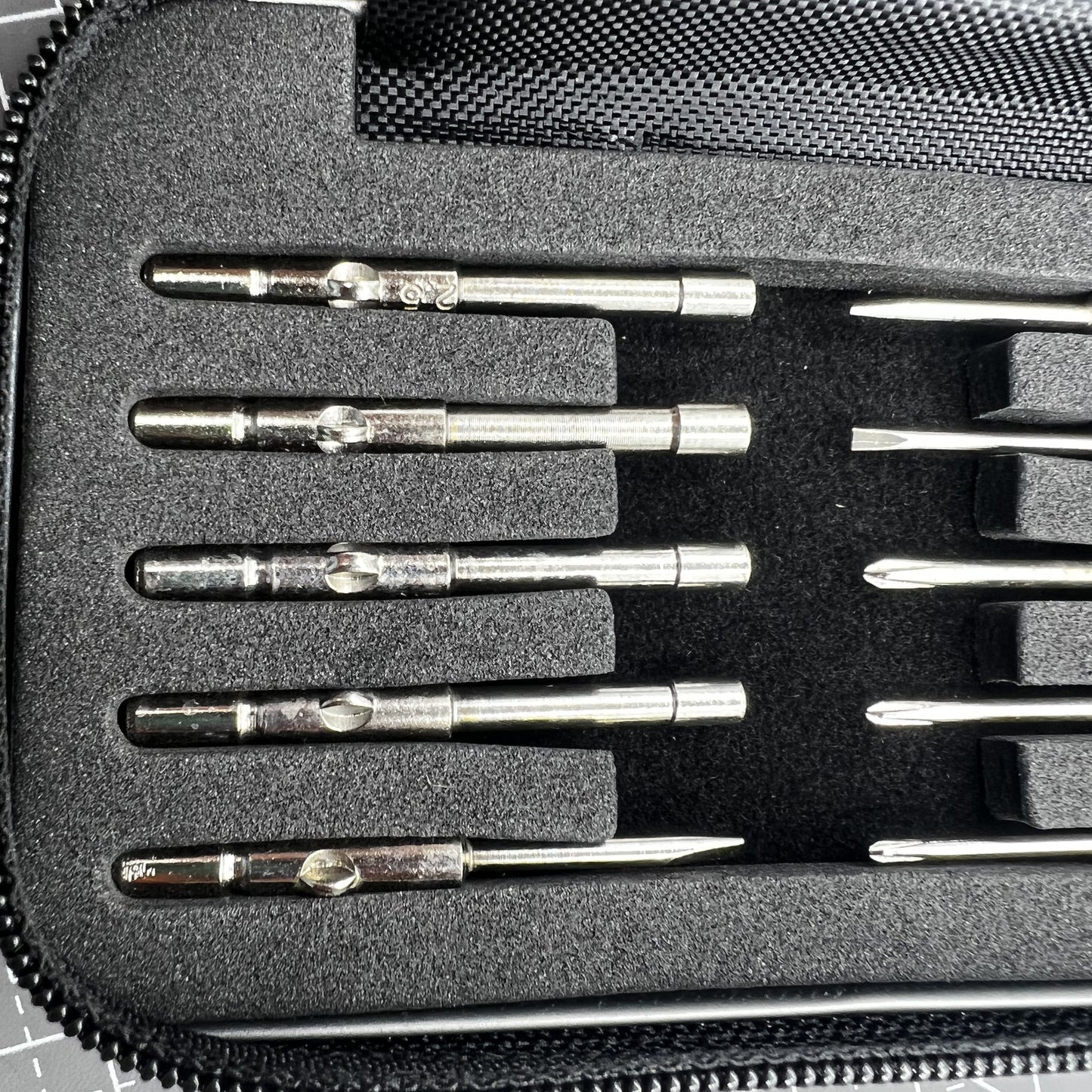 Precision screwdriver set with hex tools for watches and glasses repair, ergonomic grip.