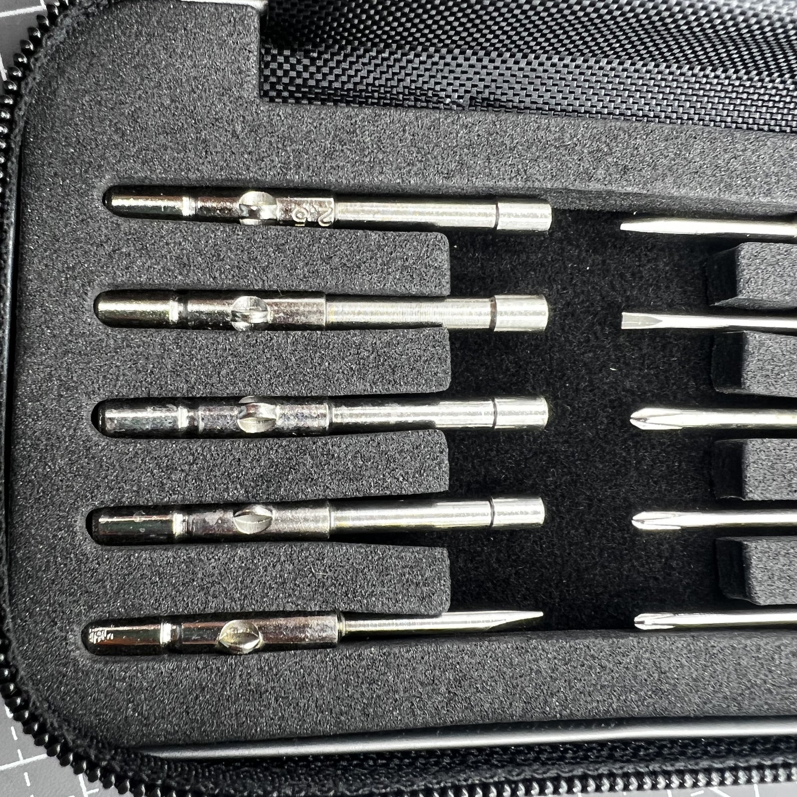 Precision screwdriver set with hex tools for watches and glasses repair, ergonomic grip.