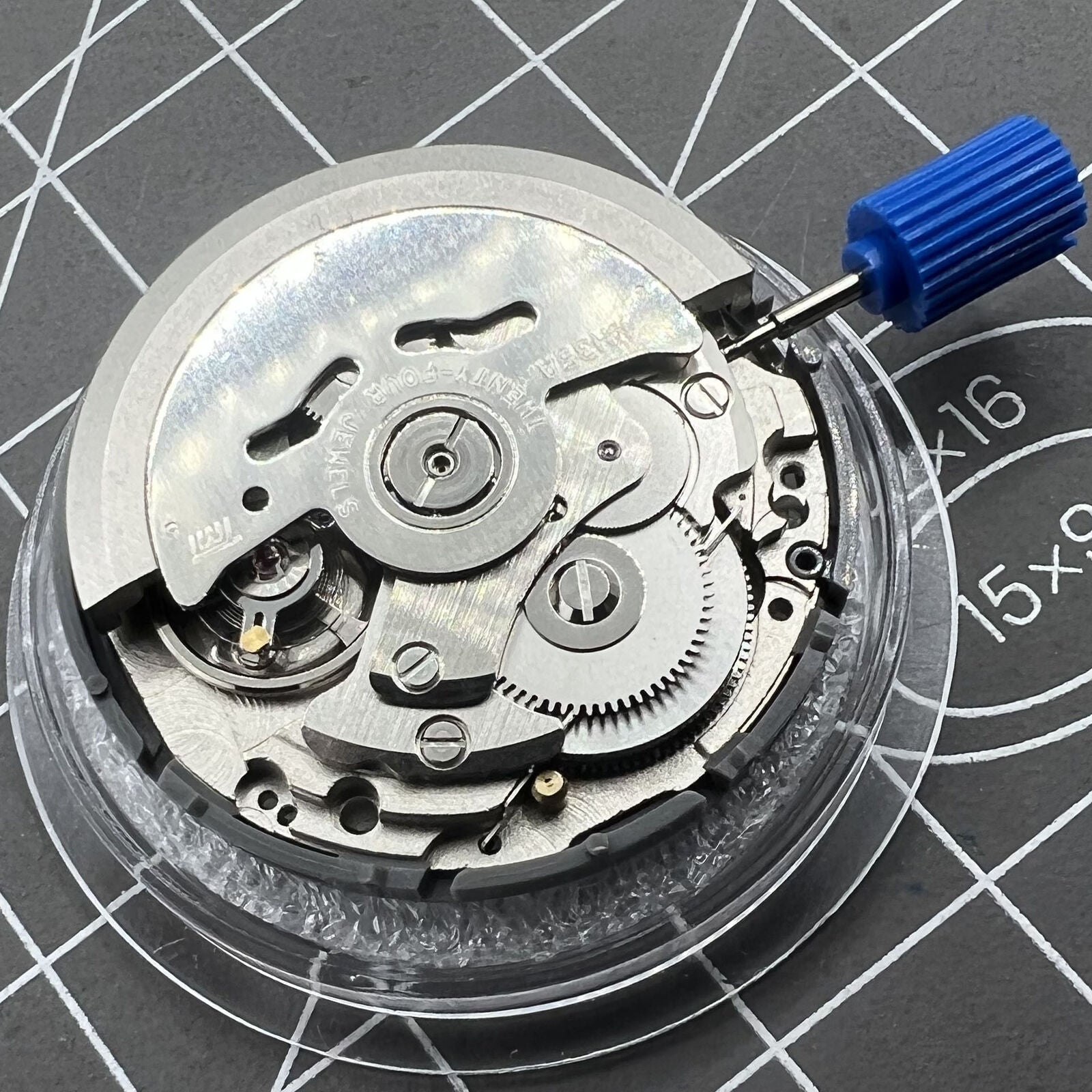 Black Seiko NH35 automatic watch movement showing date at 6 o'clock, precise self-winding mechanical component.