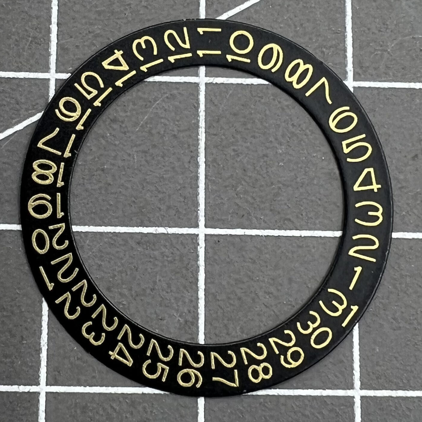 Golden date disk displaying characters on black background for Seiko NH35 NH36 movements