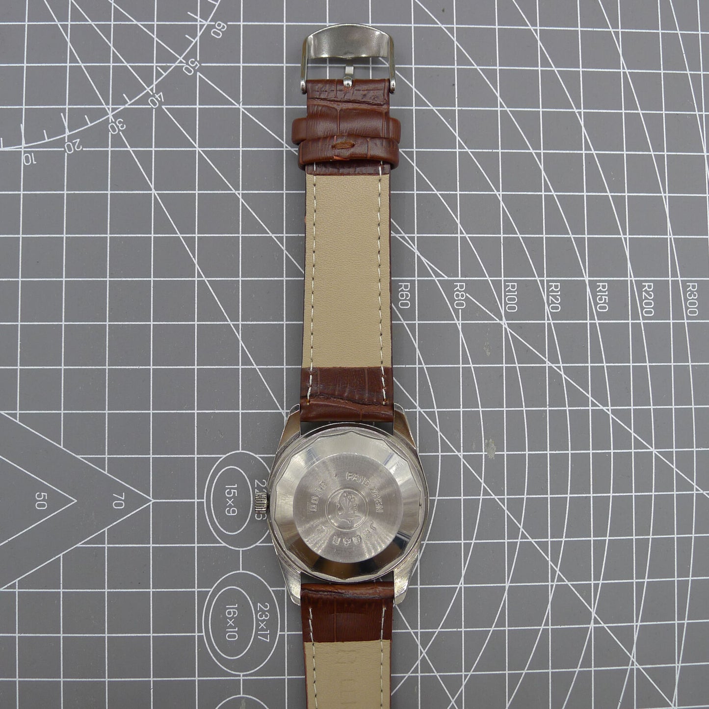 Dandong Peacock 37mm manual watch with golden dial, single calendar, 33 jewels, elegant design.