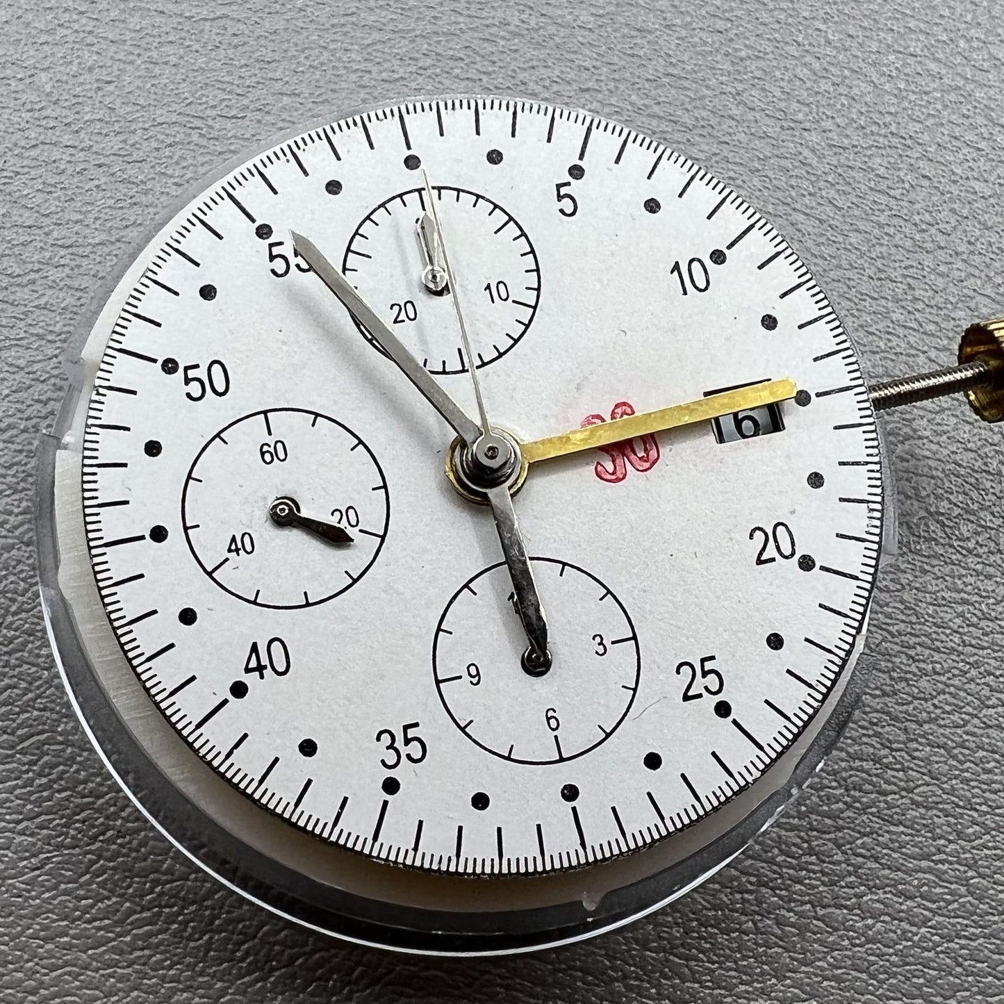 Dandong 7750 mechanical watch movement with single calendar and small second subdials at 6, 9, and 12 o'clock positions