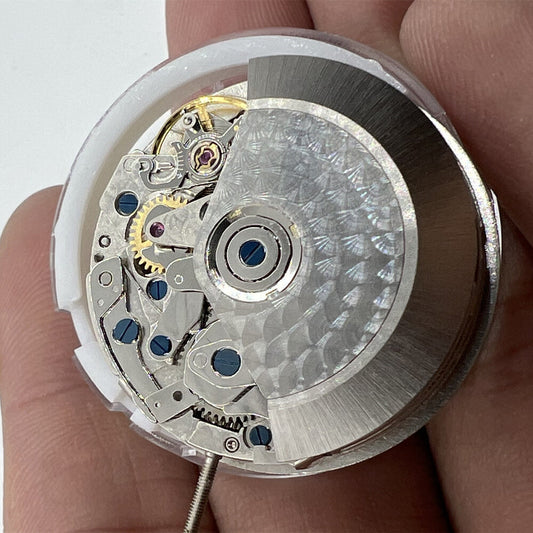 Close-up of Asian 7750 automatic chronograph movement with single calendar at 6 and seconds subdial at 9, showcasing precision engineering.