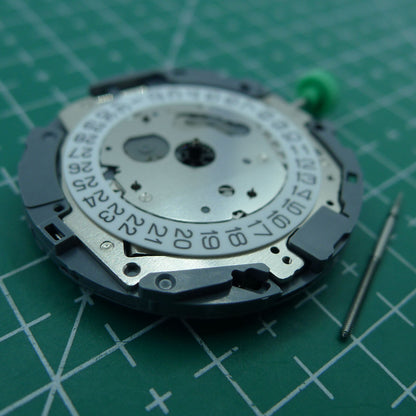 Miyota OS10 quartz watch movement showcasing date window at 3 o'clock, precise Japanese craftsmanship.