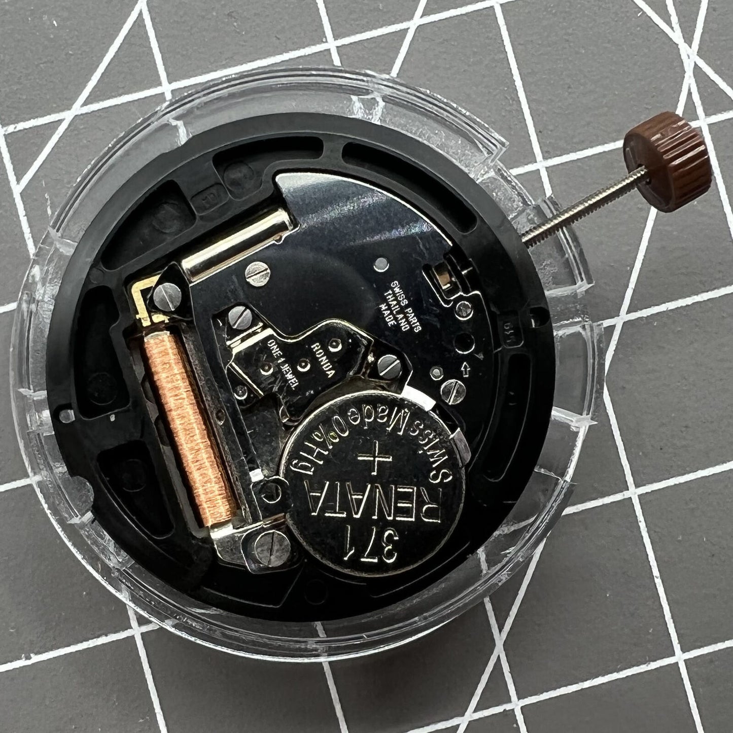 Swiss Ronda 509 quartz watch movement with black date disk at 3 o'clock, precision timing accessory.