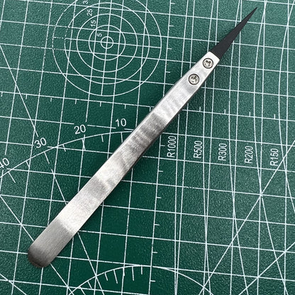 Stainless steel tweezers with carbon fiber tips for precise watch repair.