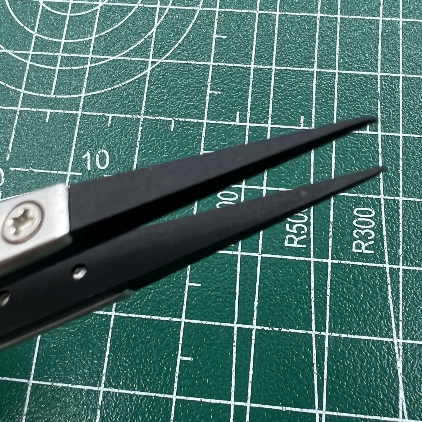 Stainless steel tweezers with carbon fiber tip for precise watch repair, durable and accurate.