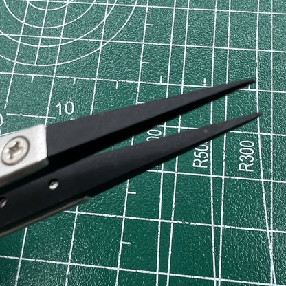 Stainless steel tweezers with carbon fiber tip for precise watch repair, durable and accurate.
