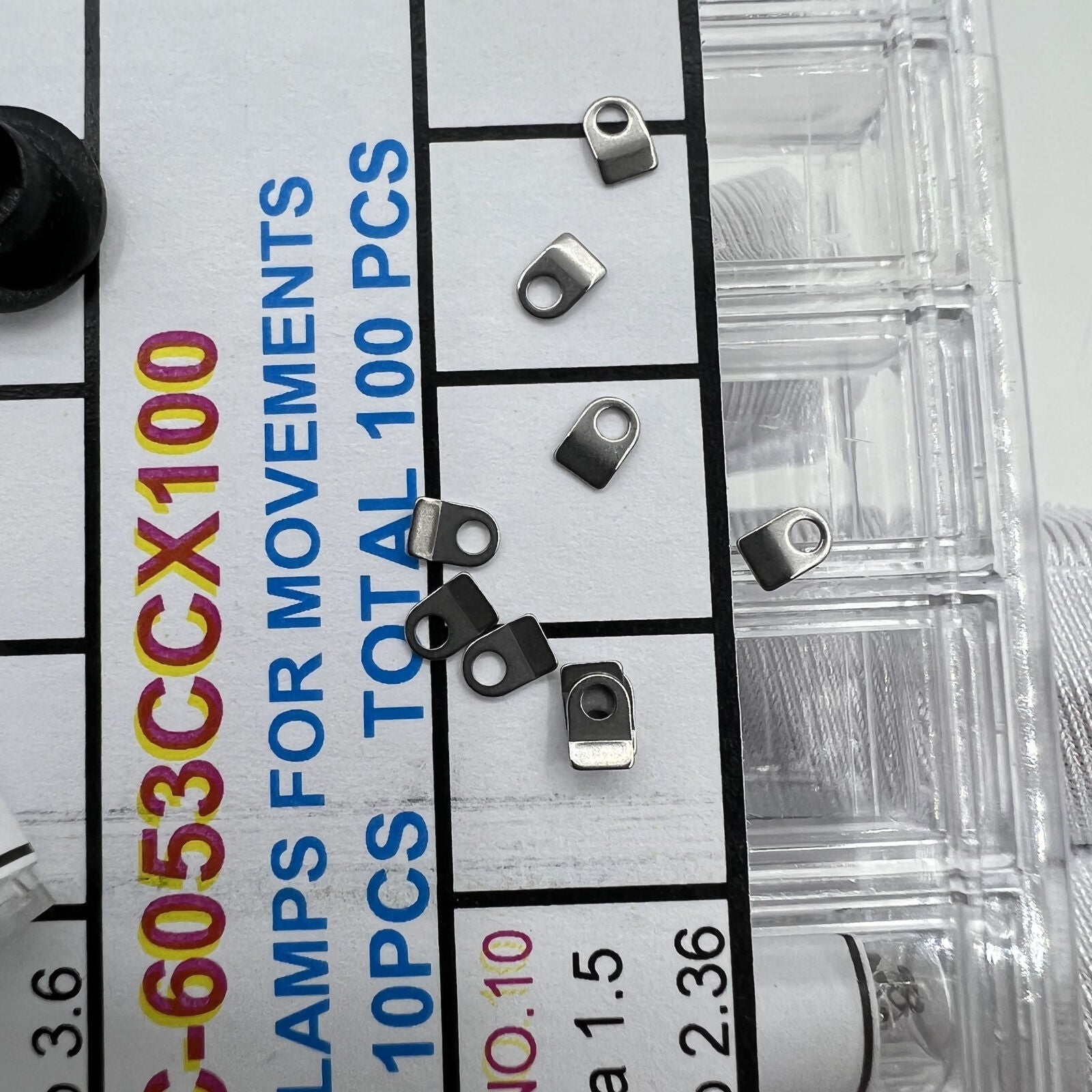 Precision fit casing clamps for watch movements, 10 sizes, 100pcs box, ideal for watch repair.