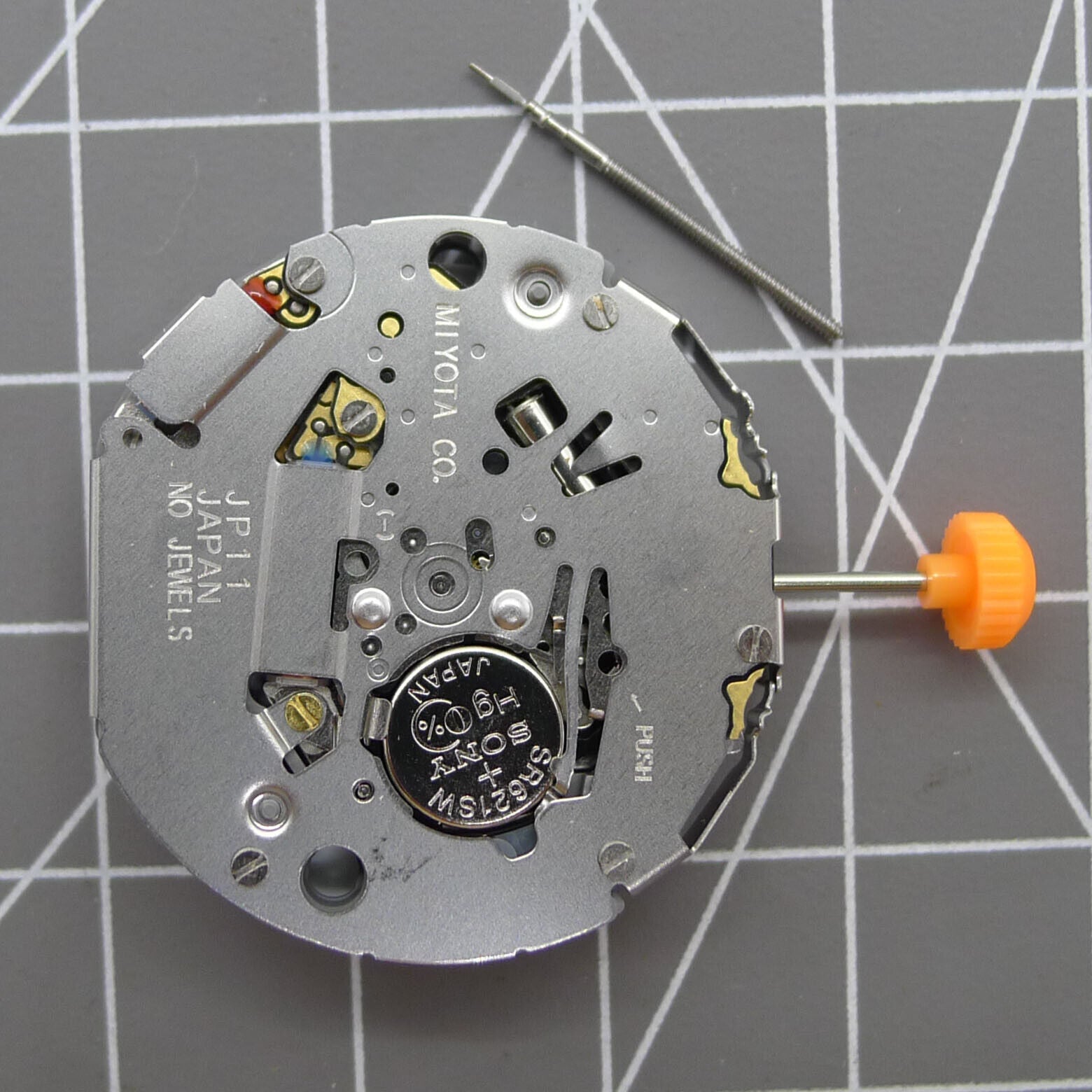 Japan Miyota JP11 quartz watch movement with date display at 3 o'clock, precision timekeeping.